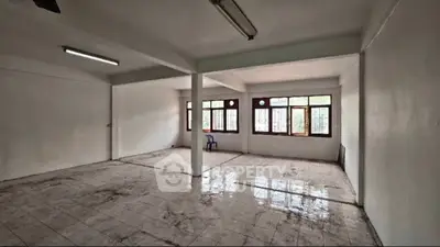 Spacious open-plan room with large windows and tiled flooring, ideal for customization.