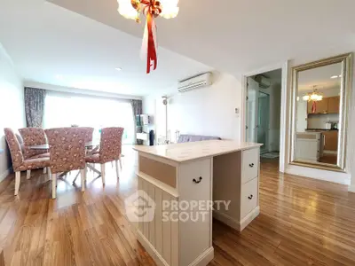 Spacious living room with elegant dining area and wooden flooring