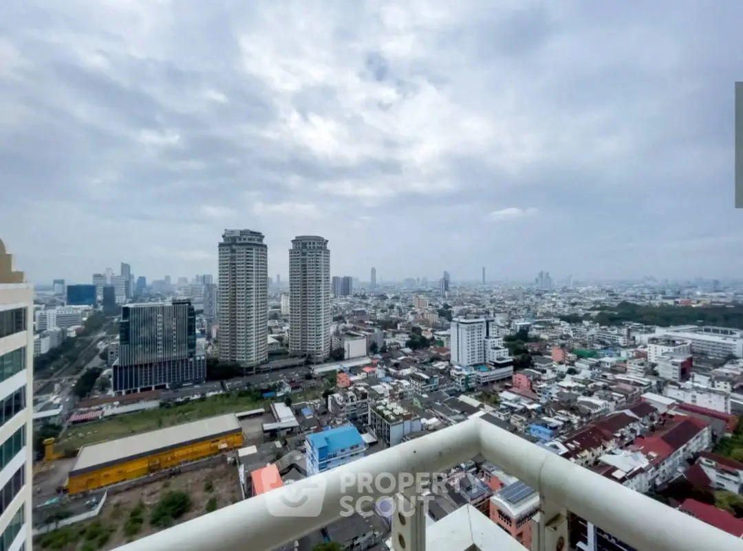 Stunning cityscape view from high-rise balcony showcasing urban skyline and expansive horizon.