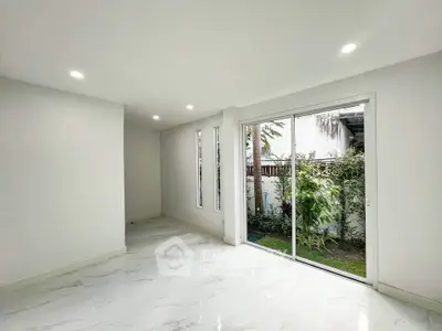 Bright and airy living room with garden view and sleek marble flooring