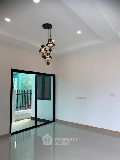 Modern interior with elegant lighting and sliding glass doors leading to a balcony.