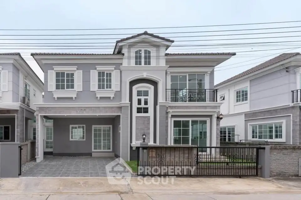 Elegant two-story house with modern design and spacious driveway in a serene neighborhood.