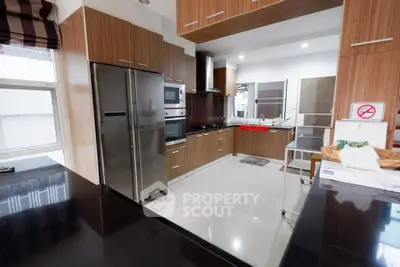 Modern kitchen with sleek wooden cabinetry and stainless steel appliances