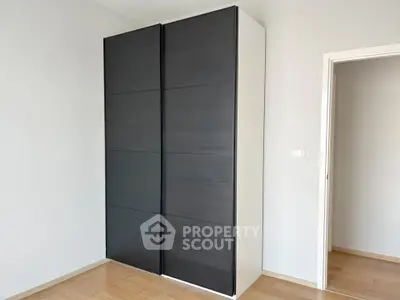 Modern minimalist wardrobe in a bright room with wooden flooring