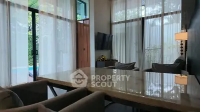 Luxurious living room with elegant marble table and pool view, perfect for modern lifestyle.