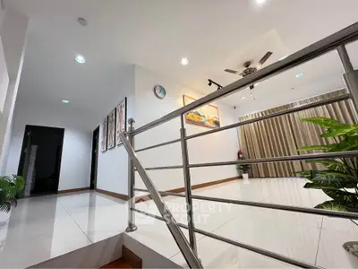 Modern interior with sleek railing and stylish decor in a spacious living area.