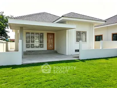 Charming single-story house with manicured lawn and modern design in a serene neighborhood.