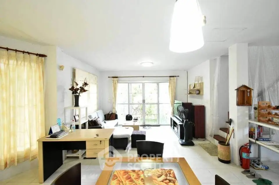 Spacious living room with natural light and modern furnishings