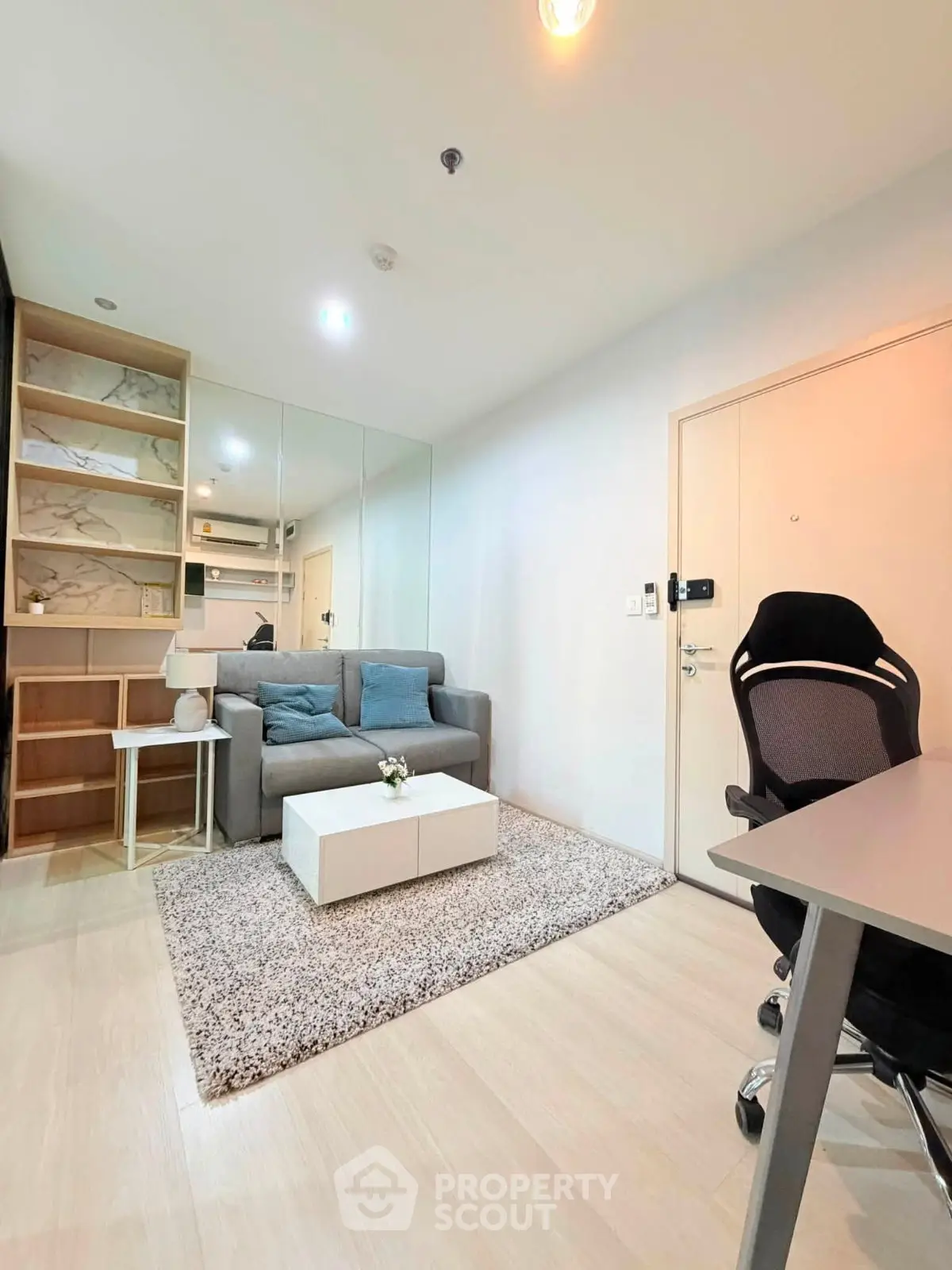 Modern living room with cozy sofa, stylish decor, and sleek furniture in a bright apartment.