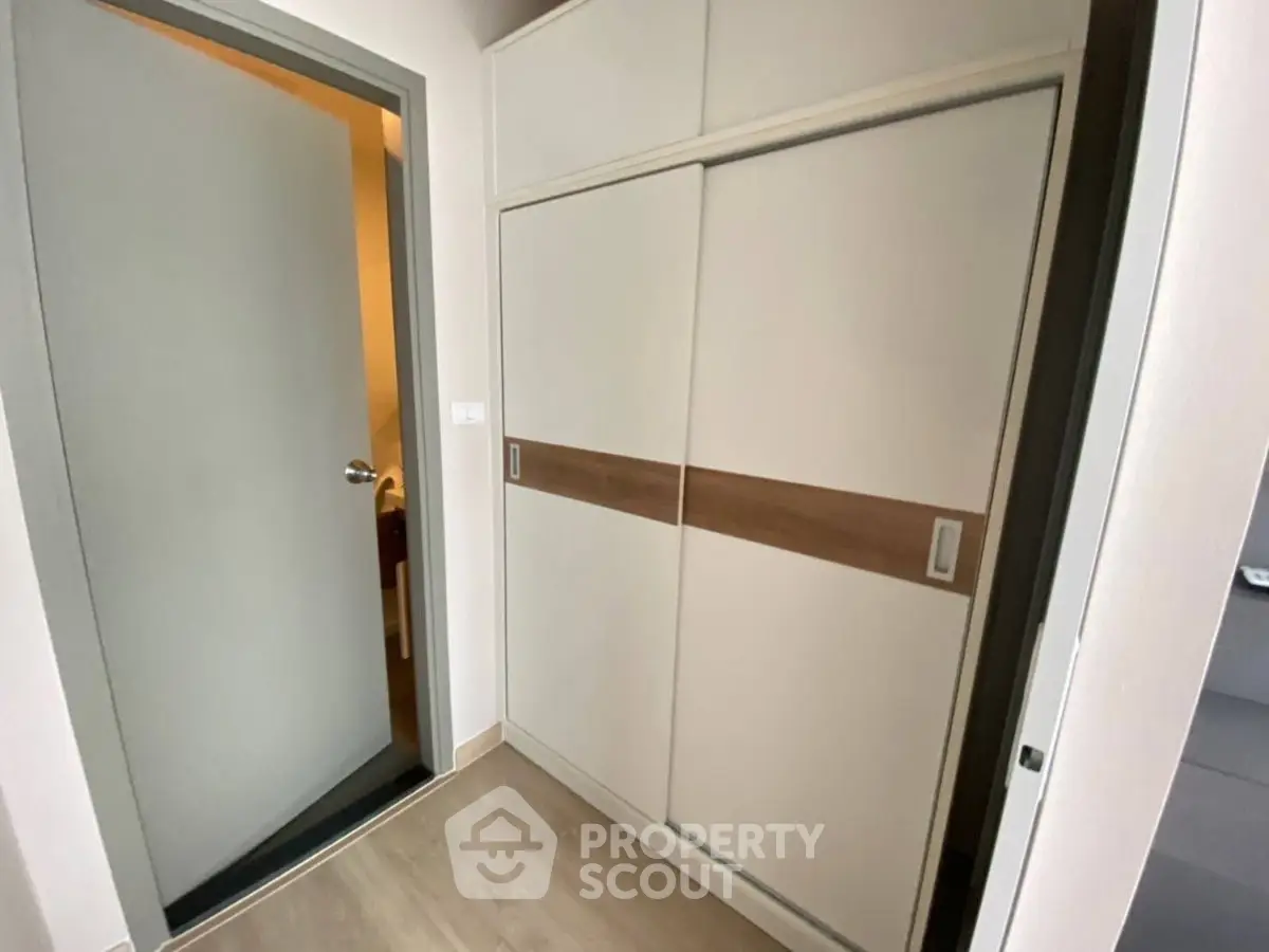 Modern apartment interior with sleek storage solutions and minimalist design.