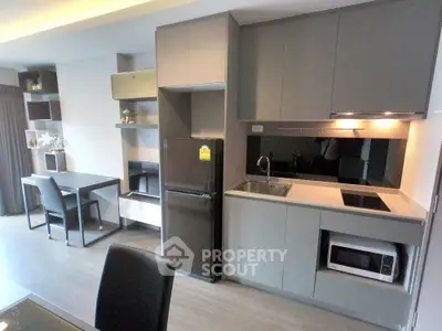 Modern kitchen with sleek cabinetry and dining area in a stylish apartment
