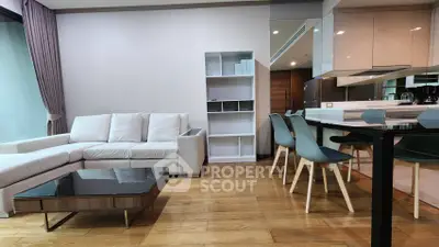 Modern living room with sleek kitchen and stylish furniture