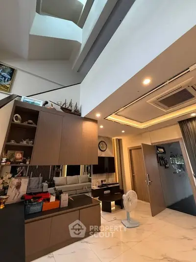 Spacious modern living room with high ceiling and elegant decor