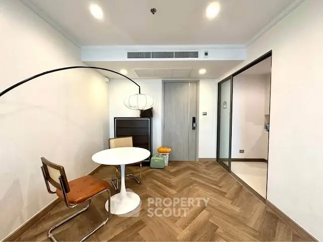 Modern living room with stylish furniture and herringbone wood flooring