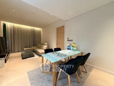 Modern living room with elegant dining area and cozy seating, featuring contemporary design and ambient lighting.