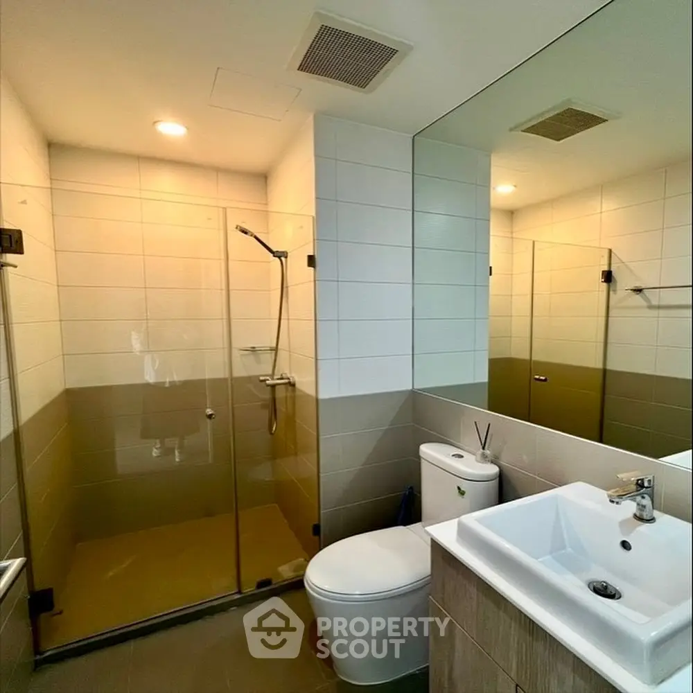 Modern bathroom with glass shower and sleek fixtures