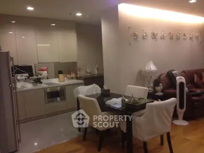 Modern open-layout kitchen and dining area with stylish decor and comfortable seating.