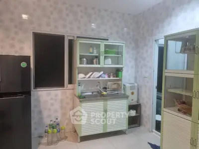 Modern kitchen with green cabinets and stainless steel sink