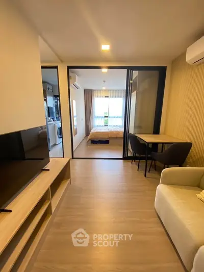 Modern apartment interior with open living room and bedroom view
