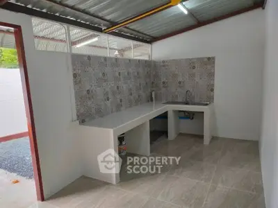 Modern kitchen with tiled backsplash and open layout in a bright space.