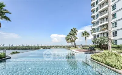 Luxurious high-rise building with stunning infinity pool and city skyline view.