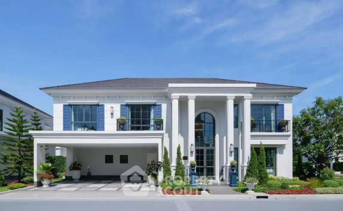 Stunning modern mansion with grand entrance and lush landscaping