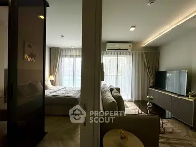 Modern open-plan living room and bedroom with stylish decor and natural light