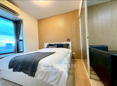 Modern bedroom with wooden accent wall and city view window