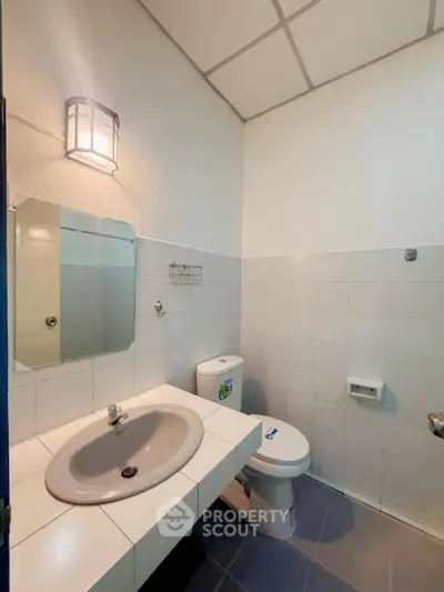 Modern bathroom with sleek fixtures and tiled walls, perfect for a contemporary home.