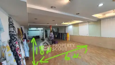 Spacious commercial space with wooden flooring and ample natural light, ideal for retail or office use.