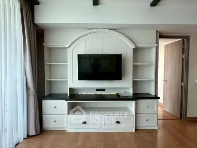 Elegant living room with built-in entertainment center and hardwood floors