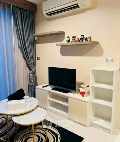 Modern living room with stylish decor, air conditioning, and entertainment center.