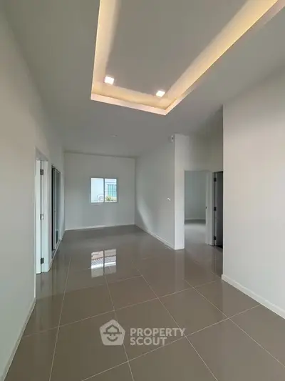 Spacious modern living room with high ceilings and sleek tile flooring