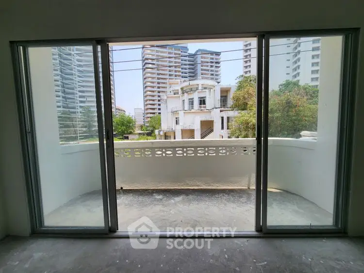 Spacious balcony with city view in modern apartment
