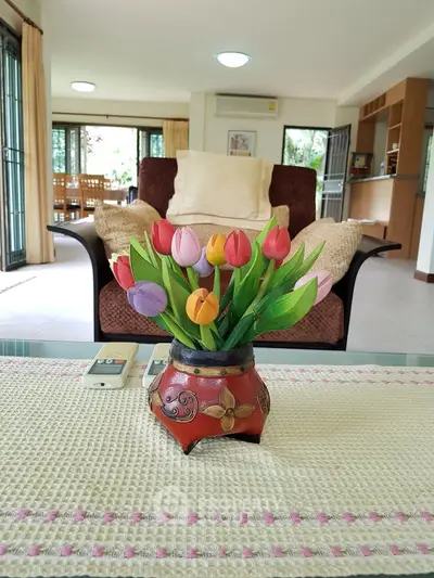 Spacious living room with elegant decor and vibrant floral centerpiece