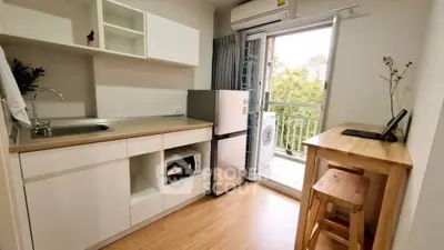 Charming kitchen with balcony view, modern appliances, and cozy dining area.