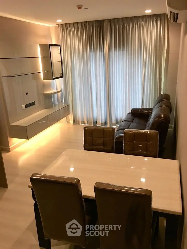 Modern living room with elegant lighting and cozy seating area, perfect for relaxation and entertainment.