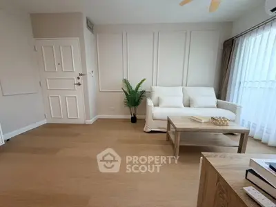Spacious modern living room with wooden flooring and natural light