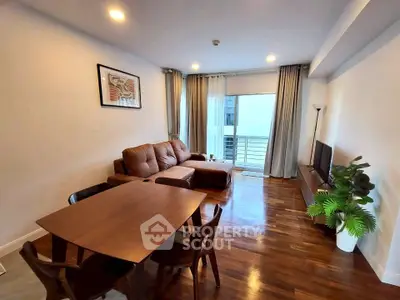 Modern living room with cozy seating and balcony view