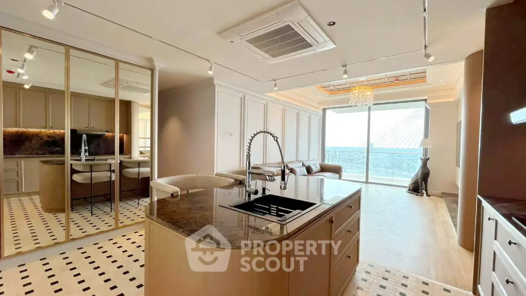 Luxurious open-plan kitchen and living room with modern design and stunning view.