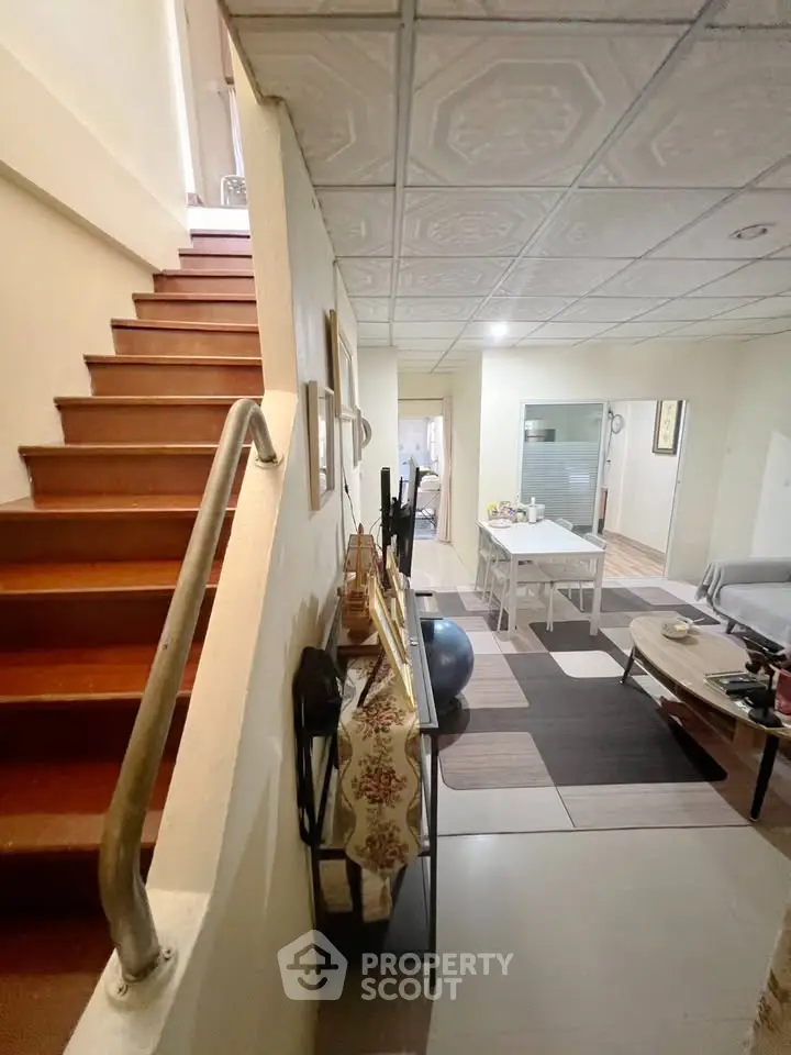 Charming interior with staircase and cozy living area, perfect for family gatherings.