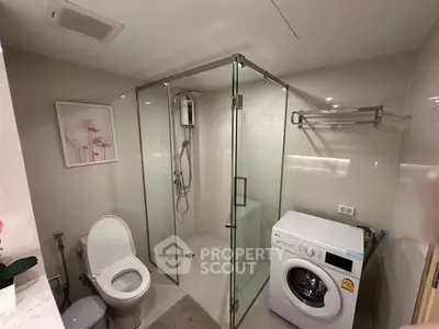 Modern bathroom with glass shower and washing machine in sleek design