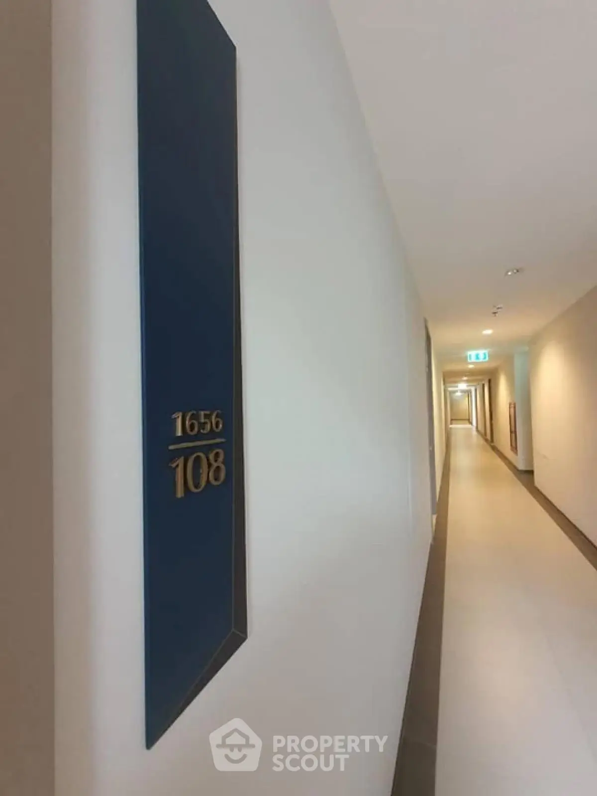 Modern apartment hallway with room number signage and sleek design