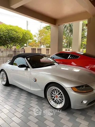 Stylish car parked in a modern residential garage with tiled flooring.