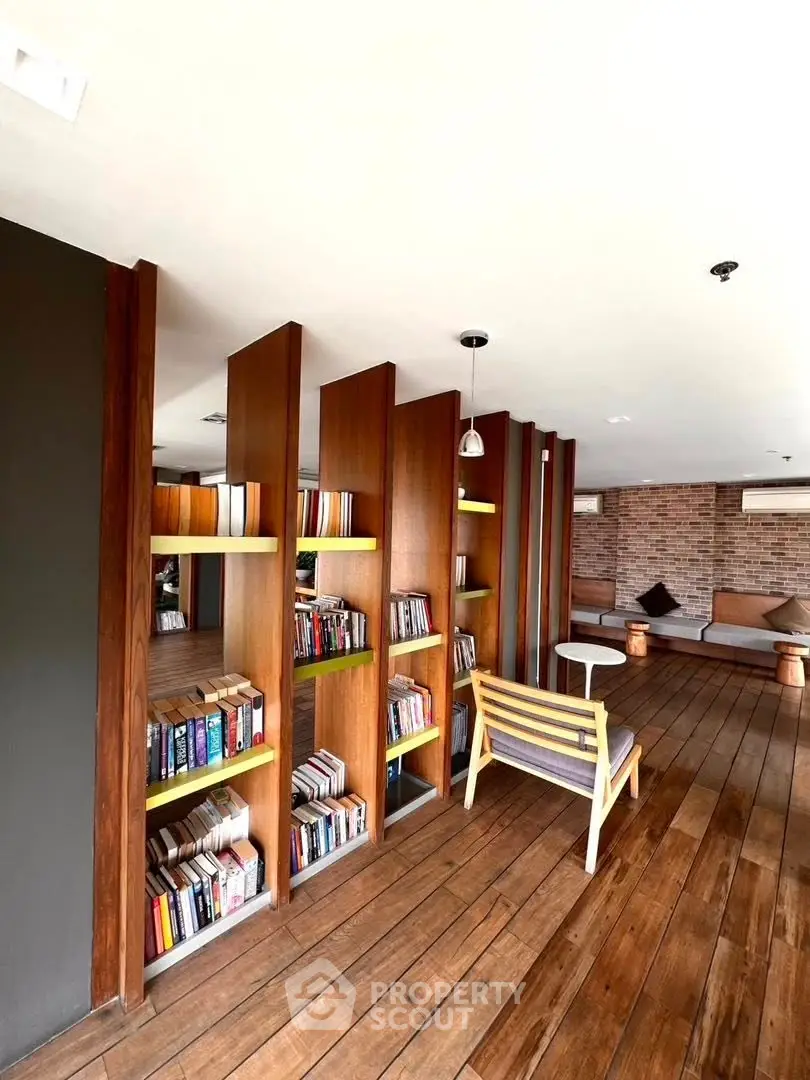 Stylish library with wooden flooring and modern seating in a contemporary building.