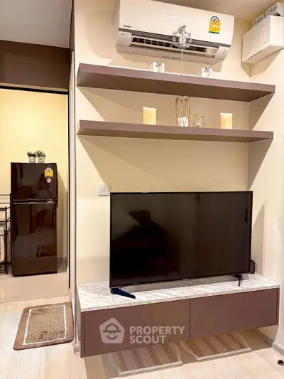 Modern living room with sleek TV setup and air conditioning