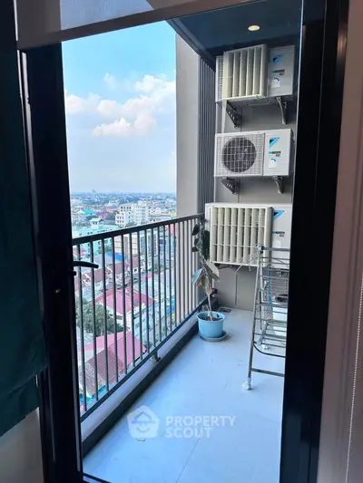 Modern balcony with city view and air conditioning units, perfect for urban living.