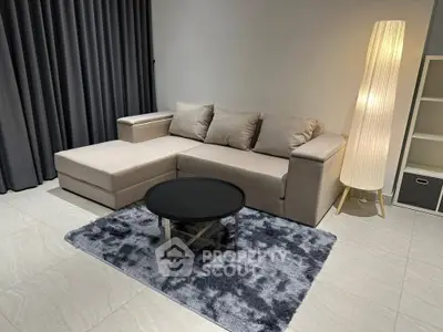 Modern living room with stylish sofa, elegant floor lamp, and chic decor
