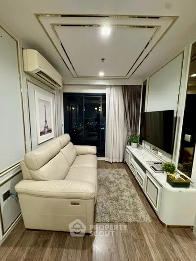 Elegant living room with modern decor, cozy sofa, and city view from large window.