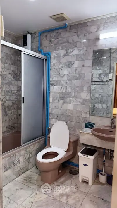Luxurious marble bathroom with modern fixtures and elegant design.